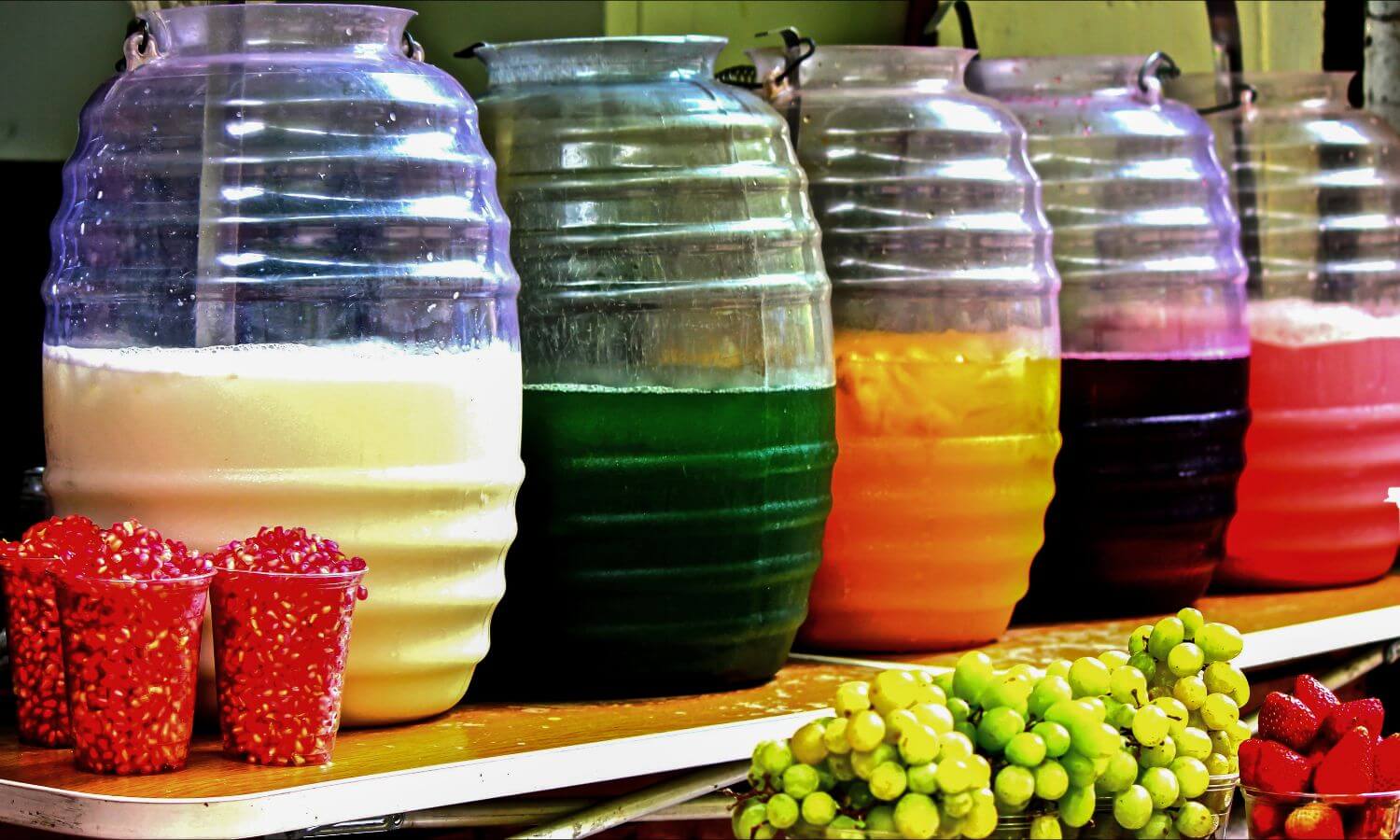 Large jars of Aguas Frescas in a Market