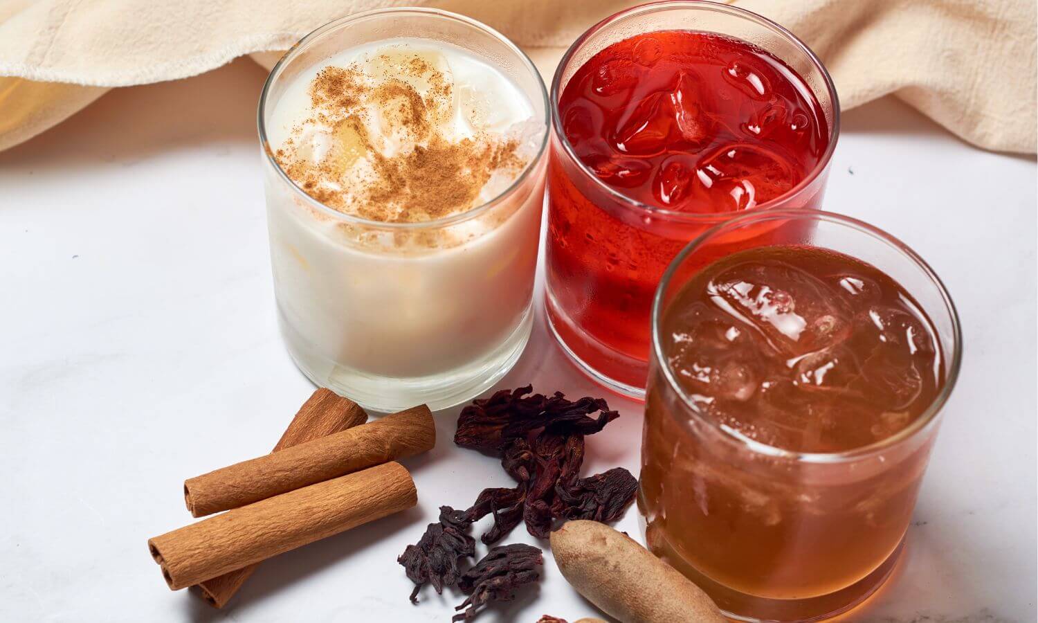 Glasses of Horchata, Tamarindo and Jamaica, classic refreshing drinks found throughout Mexico.