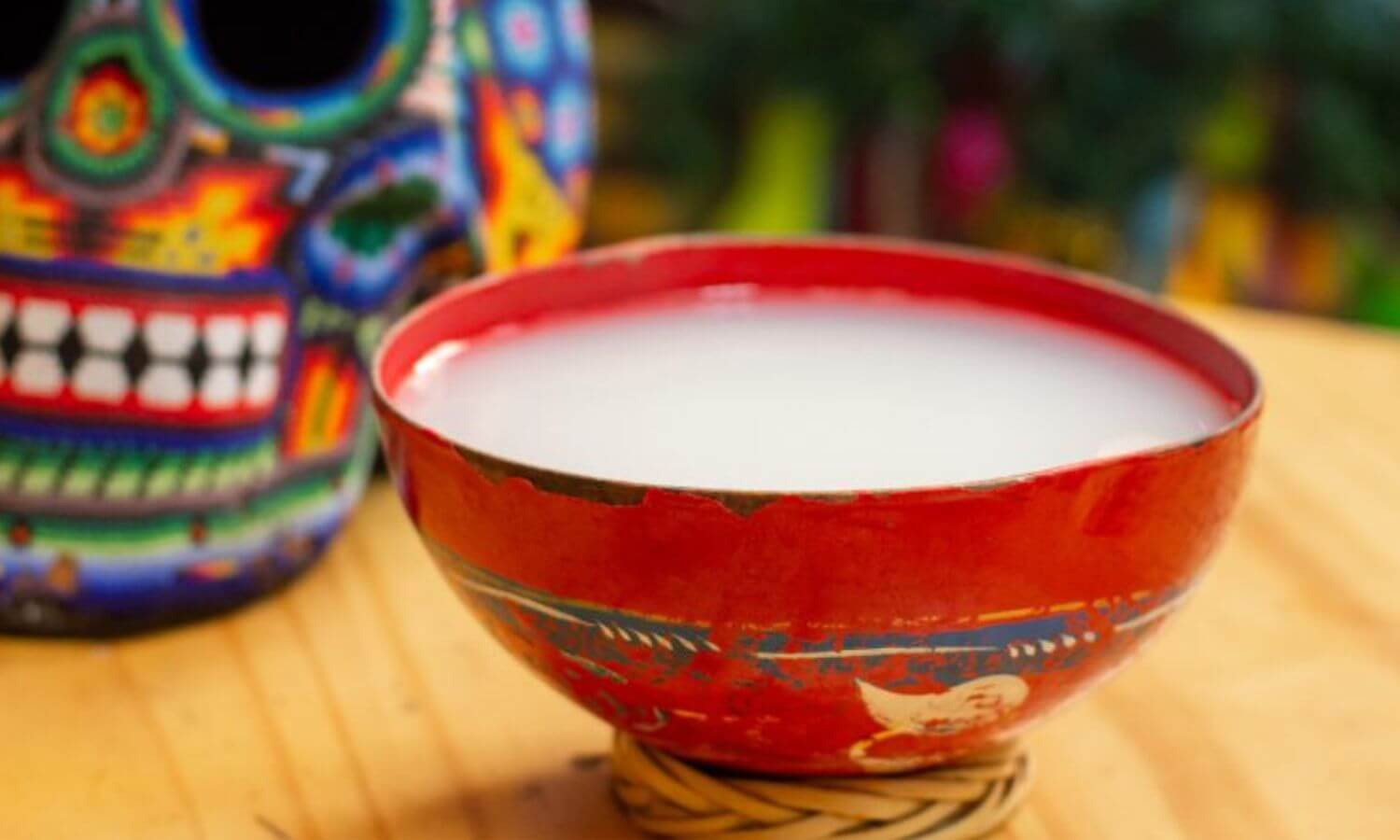 Pulque served in a traditional hand painted gourd.
