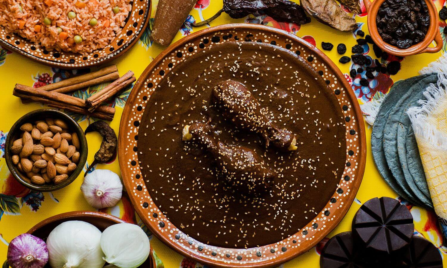 A platter of Chicken Mole surrounded by some of the ingredients at the Feria del Mole Poblano in Puebla