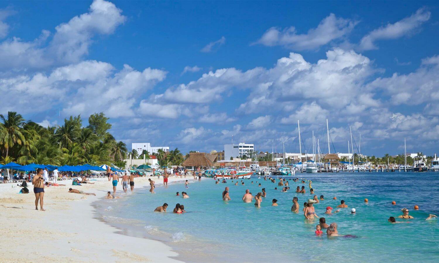 People on the beach and in the ocean at Playa Centro, Isla Mujeres