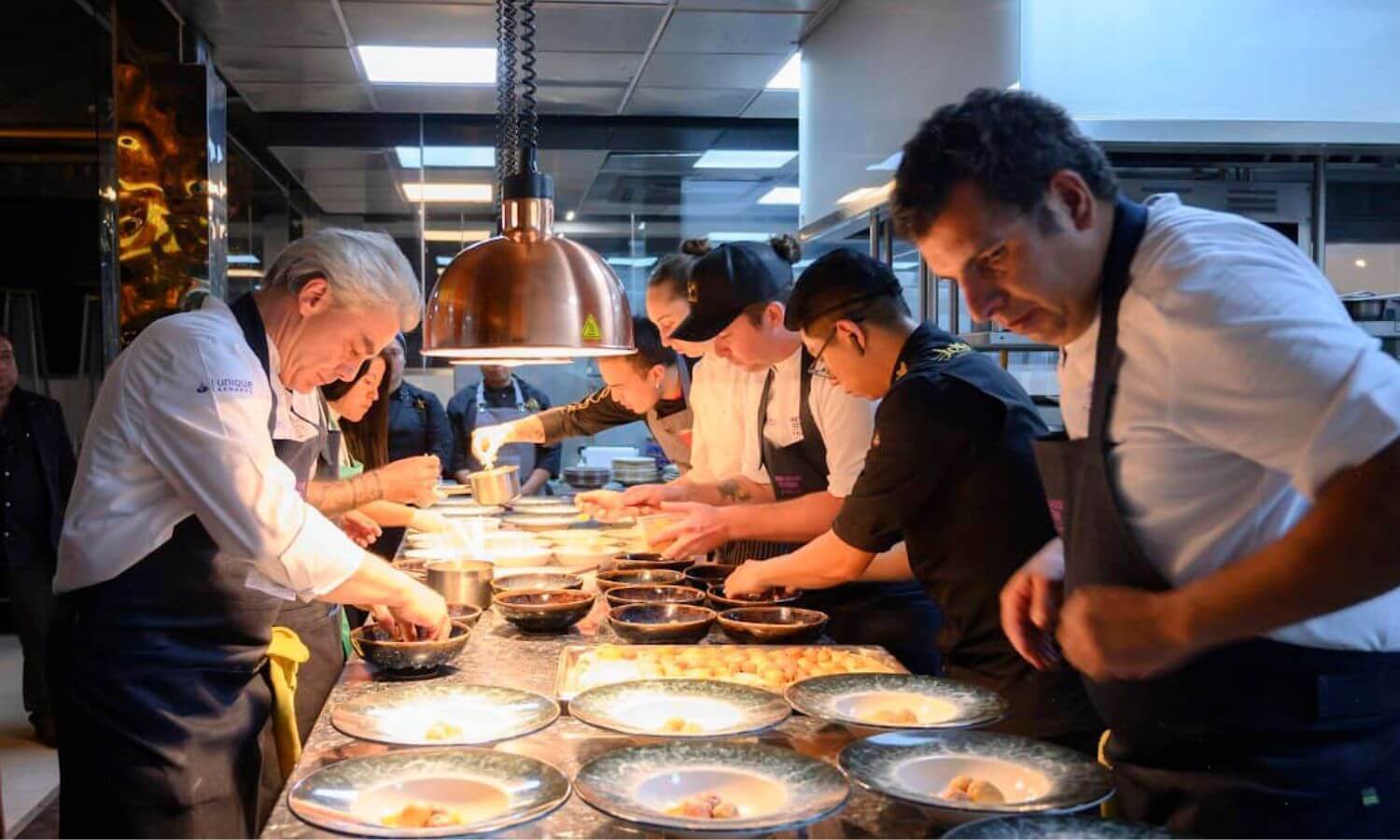 Food being plated up in a busy kitchen at a Wine and Food Festival in Mexico City