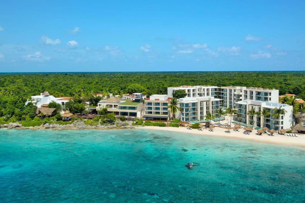 Dreams Cape Resort from the ocean showing the tropical greenery that surrounds it.