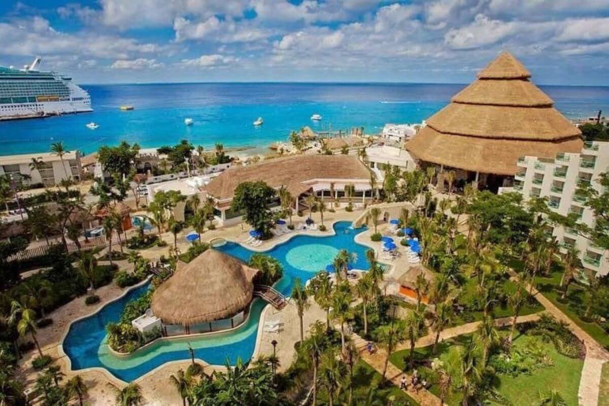 Looking from the hotel over the pool and out to a cruise ship in the ocean at the Grand Park Royal Resort in Cozumel.