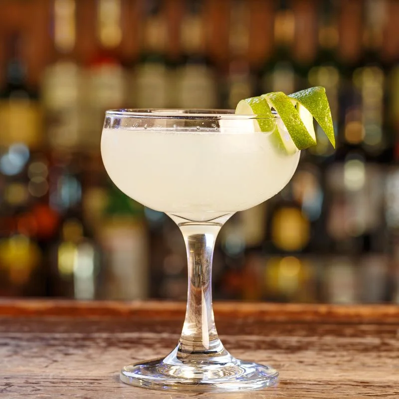Margarita With Twist Of Lime Classic margarita on a bar with a twist of lime