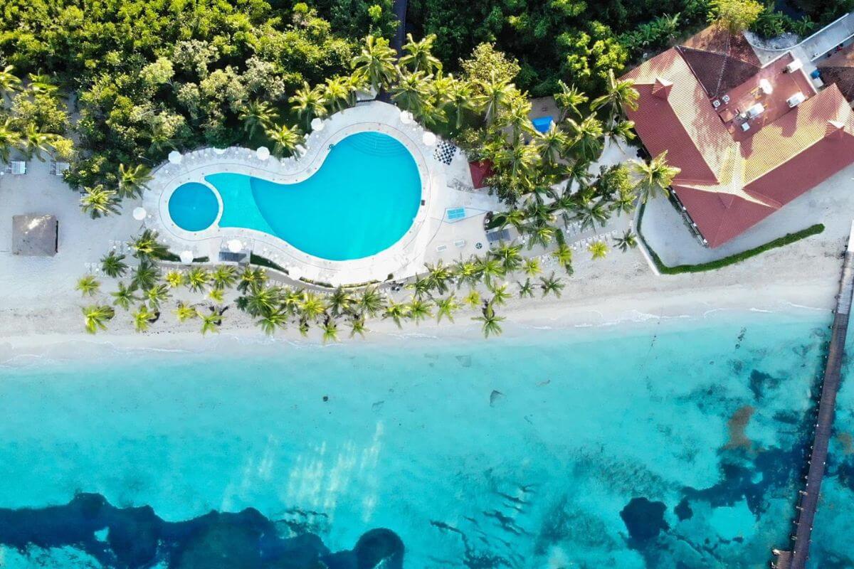 A drone shot looking straight down on the pool, beach and building of the Occidental Resort in Cozumel.