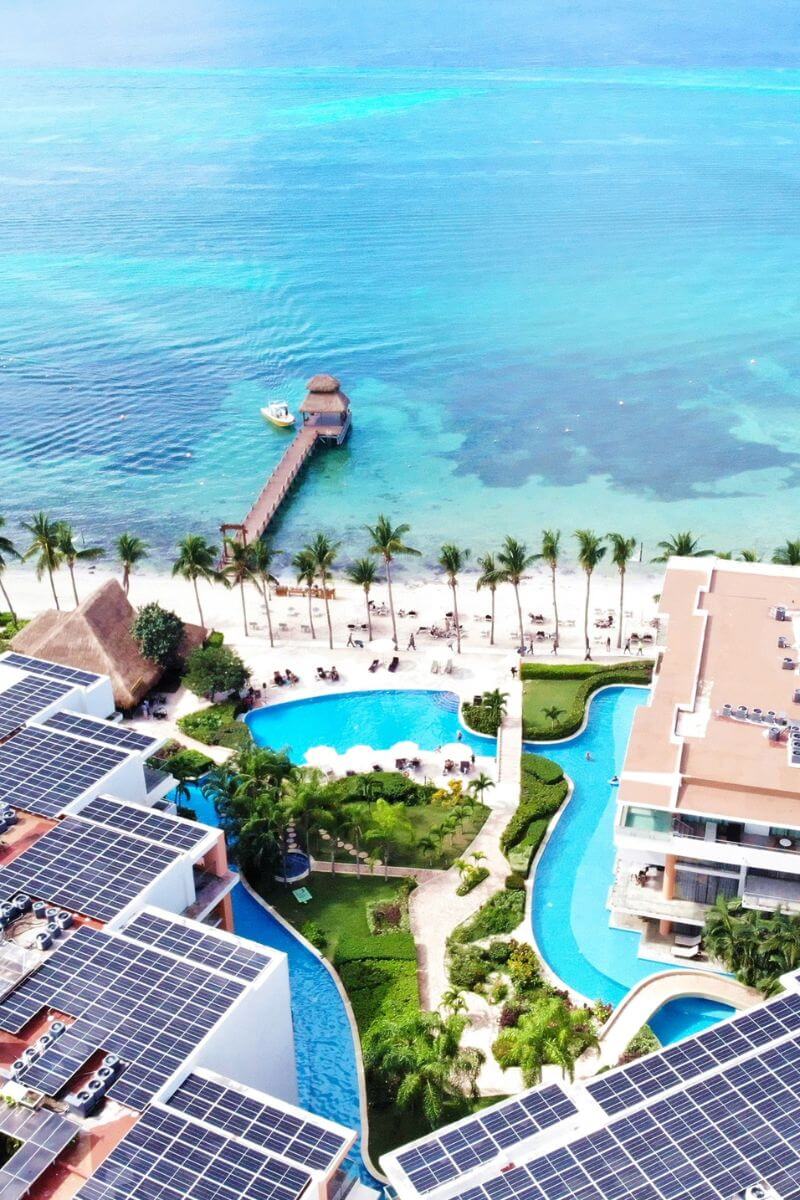 Looking over the solar paneled rooves, pools, beach and ocean at Secrets Aura Cozumel.
