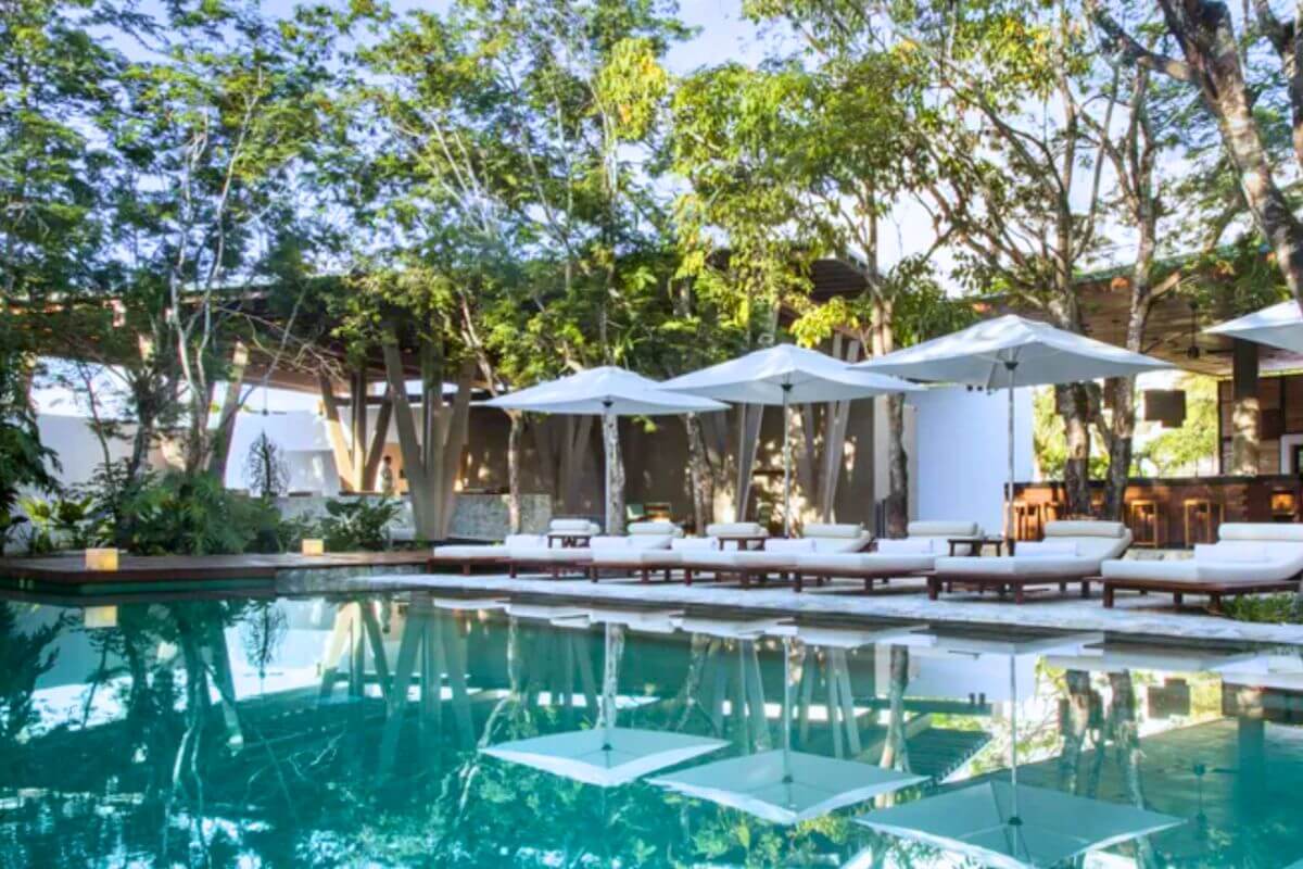 The Explorean pool surrounded by loungers and umbrellas.