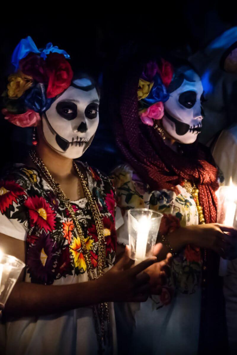 Two women dressed for Dia de Los Muertos