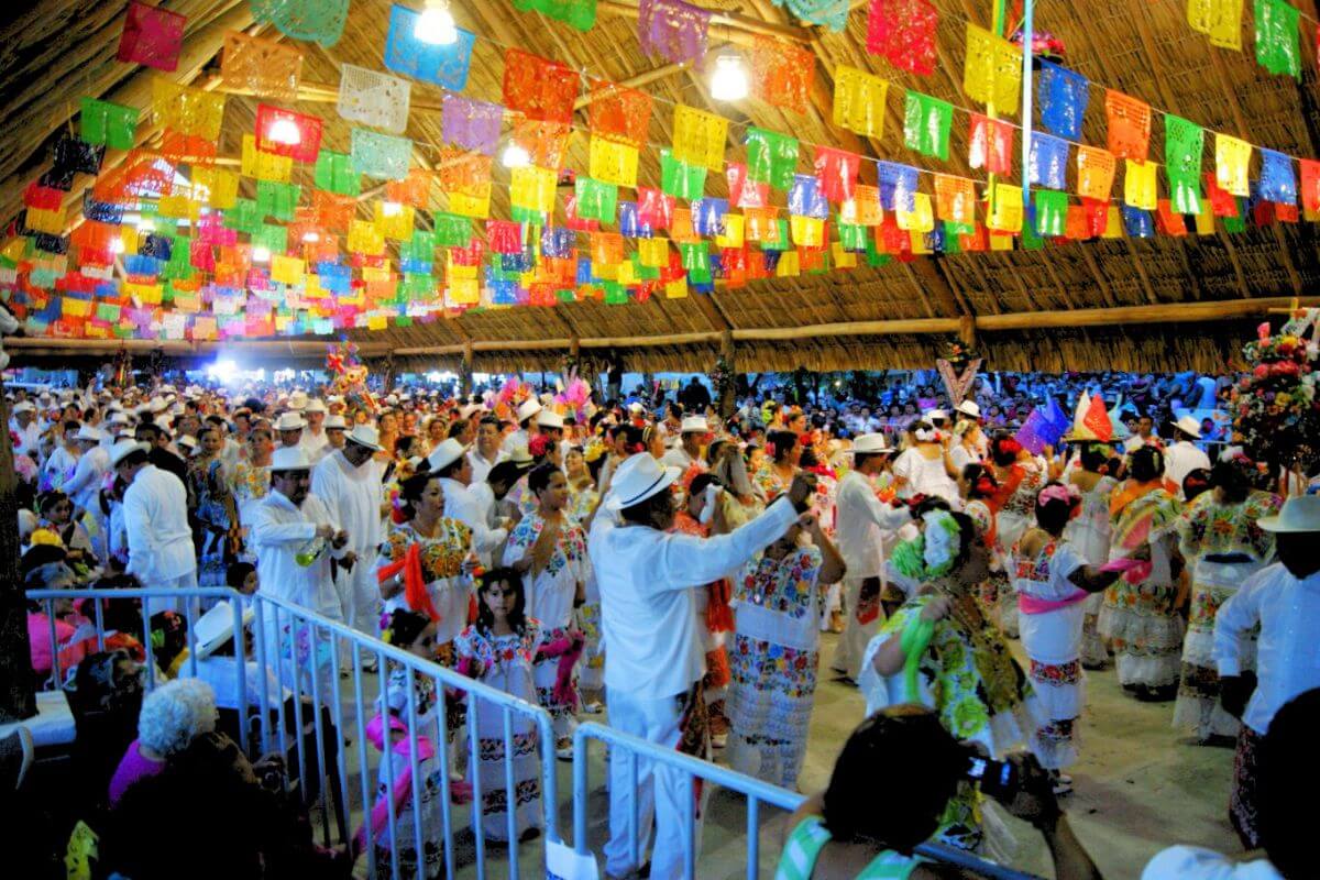Many people dancing in a huge palapa for Feria El Cedral Cozumel