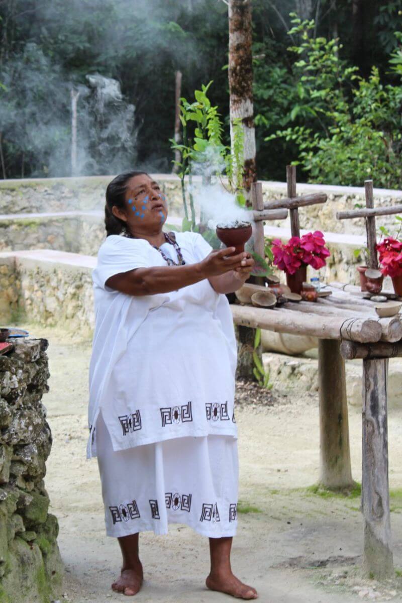 A woman performing a Purification Ceremony at Kun Che park in Cozumel