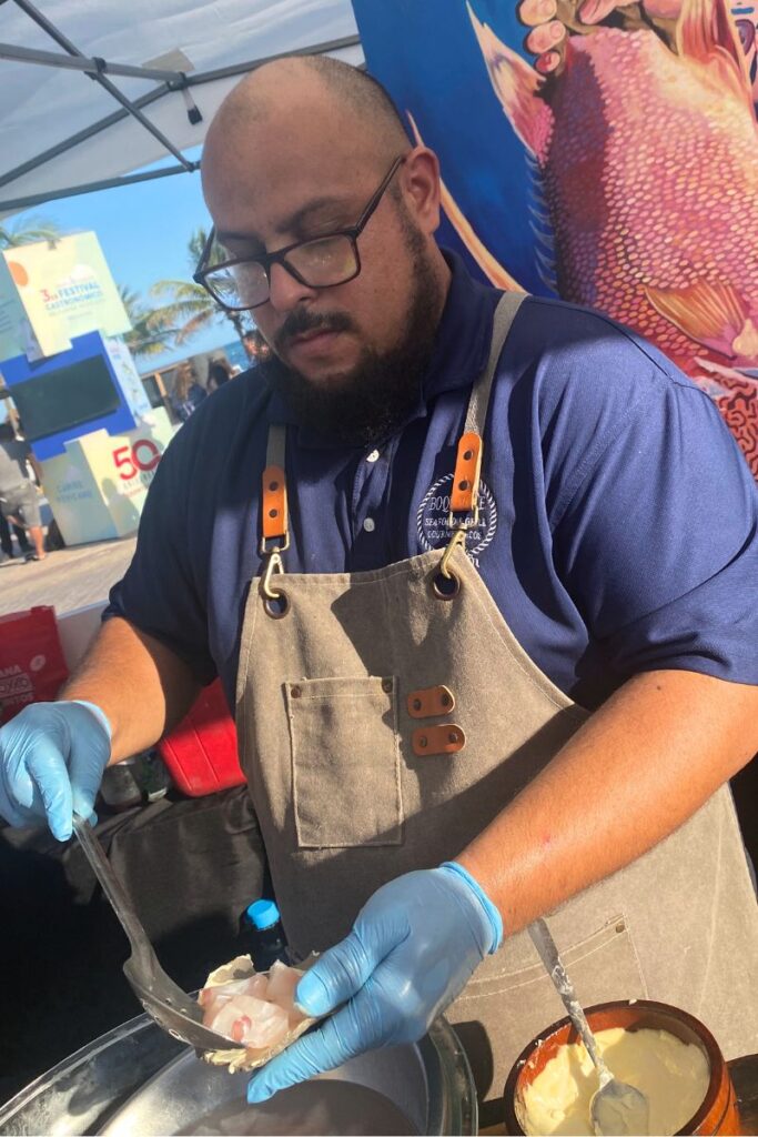 A man serving up one of the dishes in a stall at the Mexican Caribbean food festival.