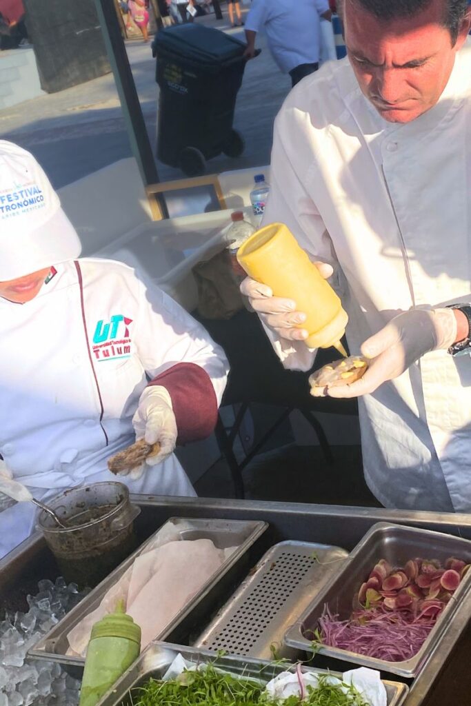 assembling the wonderful raw fish tostadas at the Mexican Caribbean Food Festival