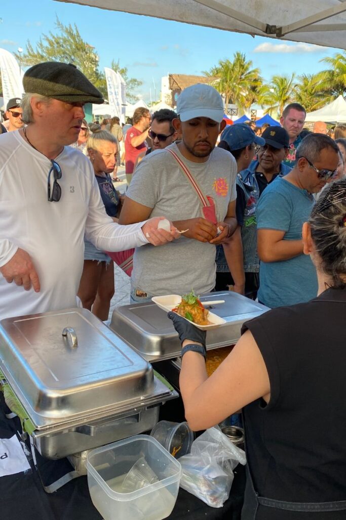 People being served at one of the stands at the Mexican Caribbean Gastronomic Festival