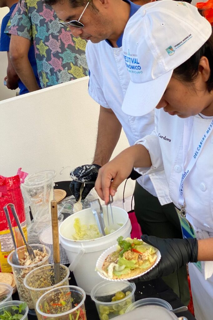 A dish of raw fish being served on a tostada at the Mexican Caribbean Gastronomic Festival.