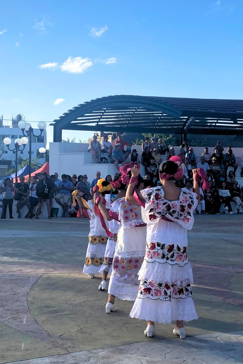 Women in traditional dress dancing at the Mexican Caribbean Gastronomic Festival, held in Puerto Morelos in 2024.