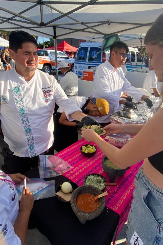 My daughter getting tacos from one of the vendors at the Mexican Caribbean Food Festival in Puerto Morelos.
