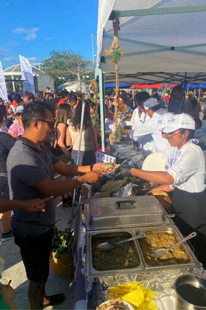 Tortas being served to a line of customers at the Mexican Caribbean food festival.