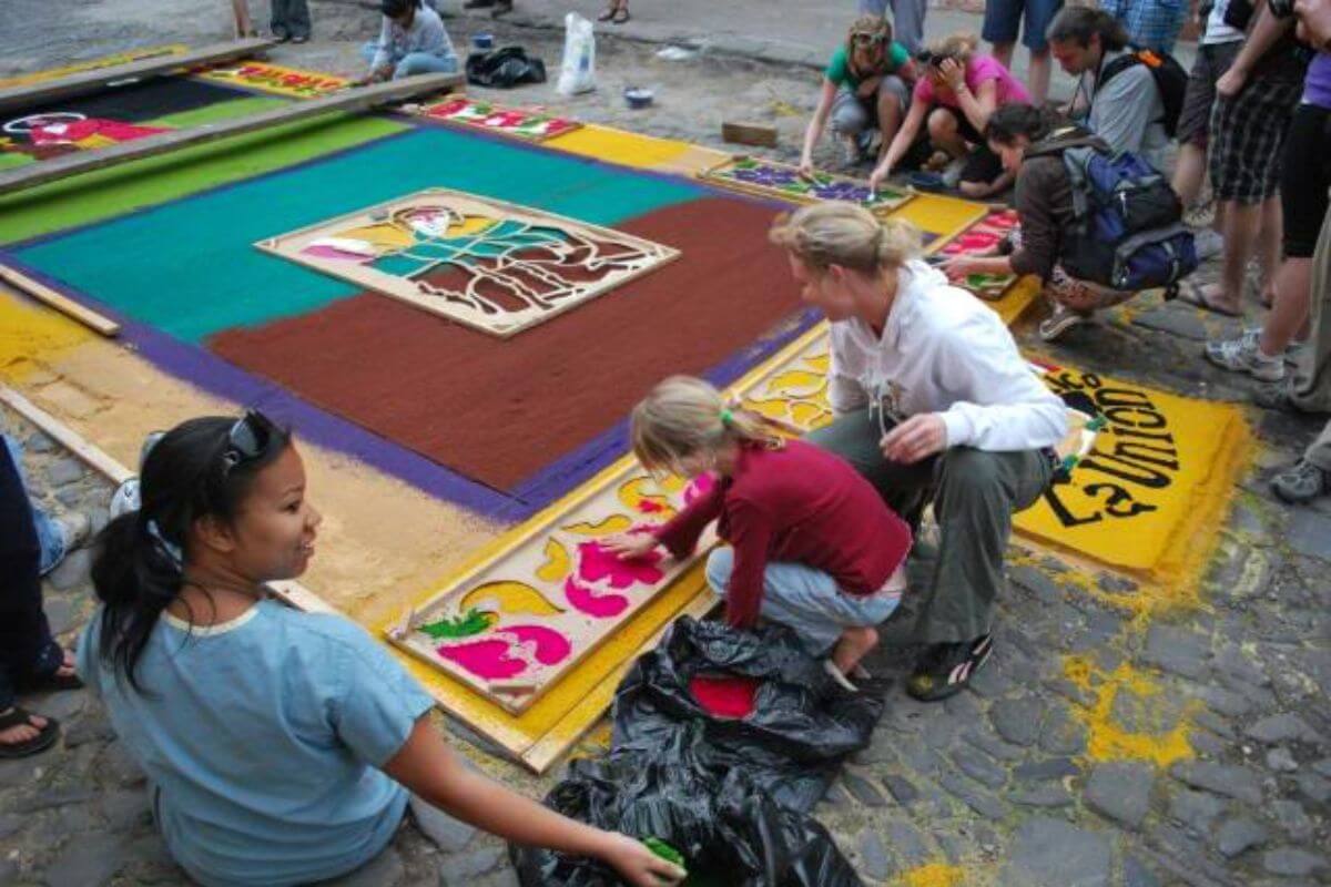 A group of people decorating Alfombras in Mexico.