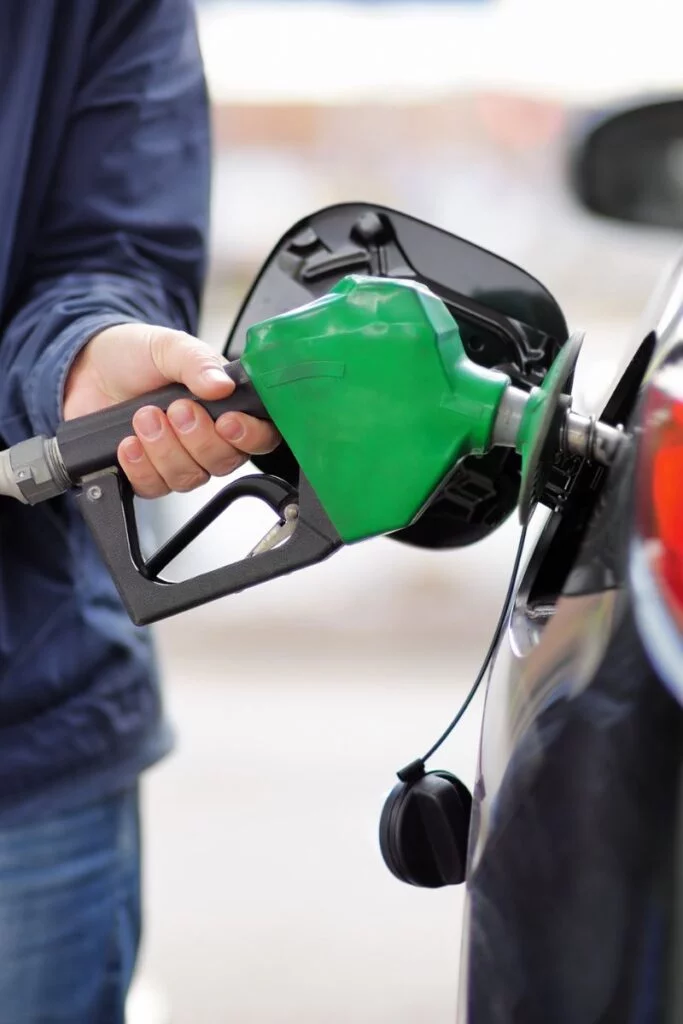 Image of a man pumping gas into a car