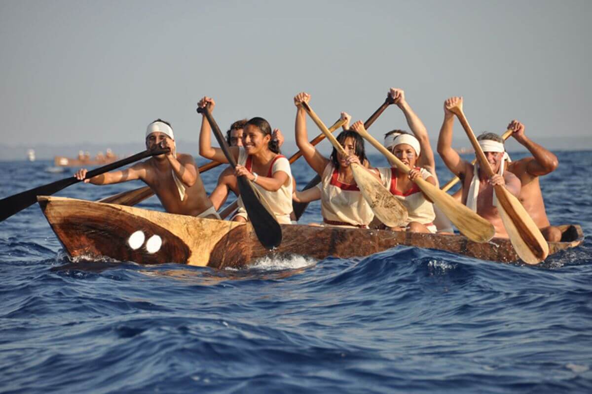 group of canoers paddling in the travesia sagrada maya on the open sea