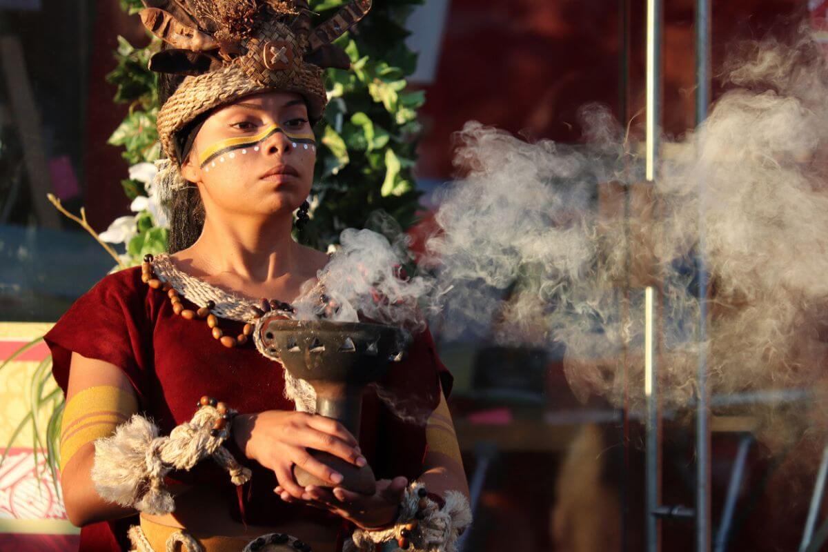 a maya priestess with a holder of smoking copal