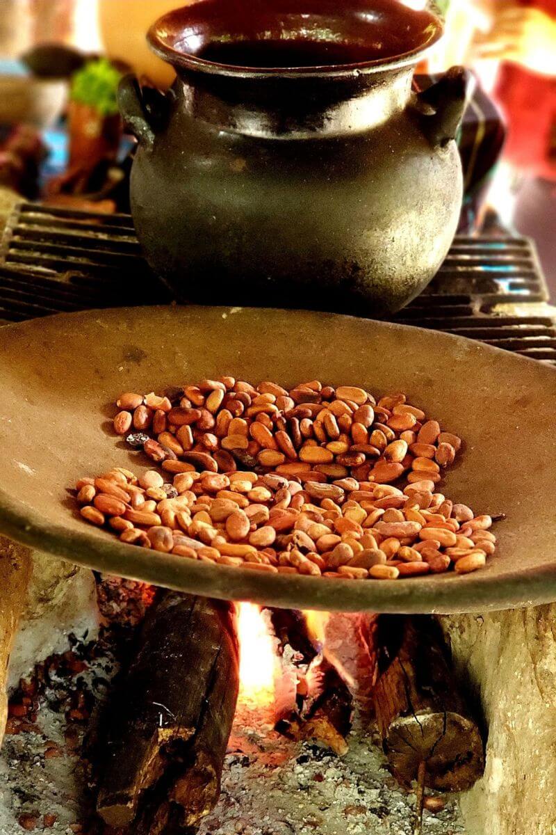 Chocolate In Mexico Toasting cacao in a comal over fire